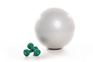 A Fitness ball and dumbell on the white floor studio
