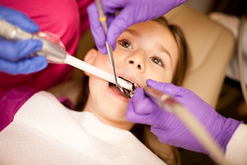 Young Girl at Dentist Getting Teeth Cleaned