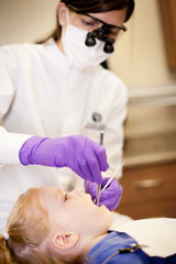 Obraz na płótnie Canvas Little Girl at Dentist Getting Teeth Cleaned