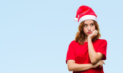 Young beautiful woman over isolated background wearing christmas hat thinking looking tired and bored with depression problems with crossed arms.