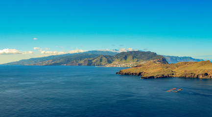 Naklejka premium Panoramic view of aride volcanic Madeira island shoreline in Portugal.