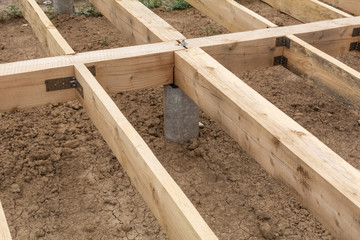 Housing frame assembly. Installation of residential building base of a-type frame house.