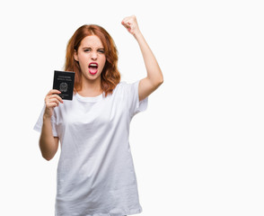 Obraz premium Young beautiful woman holding passport of italy over isolated background annoyed and frustrated shouting with anger, crazy and yelling with raised hand, anger concept