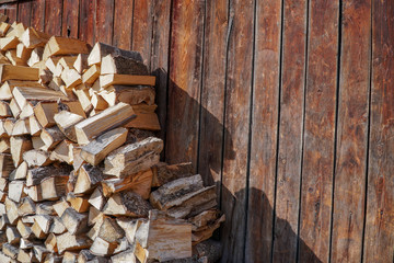 Pile of firewood.prepared to fireplace for the winter and use for cooking,firewood background,Stacks of firewood arranged in a row in the forest.Material for heating the house.Ecological natural fuel.