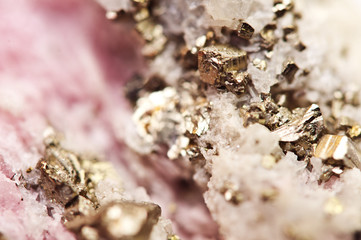Pink crystals Rhodochrosite with particles of Pyrite. Natural  texture of mineral for background. Beautiful background and wallpaper. Macro.