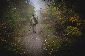 Soldier with a rocket launcher goes through the woods