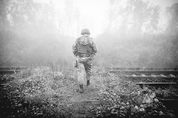 Soldier at the railroad tracks