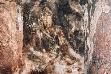 Budhha stone statue on wall in a buddhist place named as Bojjannakonda in sankaram village of visakhapatnam district of india,