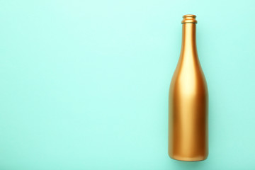 Decorated champagne bottle on mint background