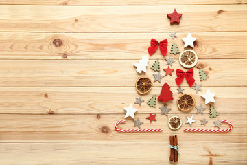 Dry fruits and decorations in shape of christmas tree on wooden table