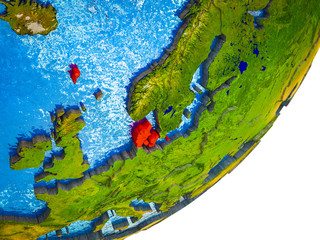Denmark on 3D model of Earth with water and divided countries.