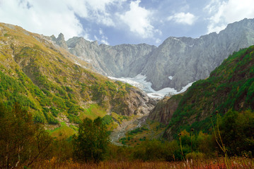 mountain landscape with a melting glacier in a valley in the North Caucasus