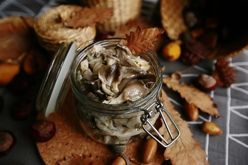 Marinated mushrooms with butter in a glass jar. Harvesting products for the winter.