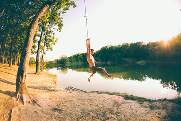 A man is riding a swing.