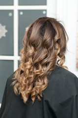 Obraz premium hairstyle female curls on dark hair