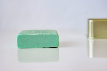 Close-up of gift box with natural olive blured soap, on a white background. Health care concept.
