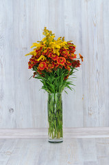 Bouquet of red and yellow flowers. Beautiful combination of colors. Mimosa. Bouquet of wild flowers.