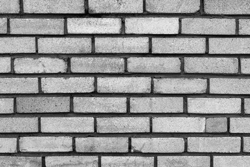 The old rectangular grey brick wall texture background.