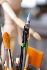 Different types of brushes for art painting are on the desktop artist.