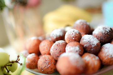 Doughnuts with a powdery sugar on the white plate