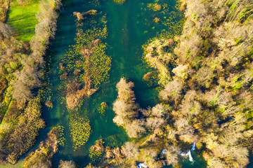 Mreznica river in Croatia from air, drone shoot, top down view, Karlovac county, green nature, wood and waterfalls in autumn 