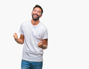 Adult hispanic man over isolated background very happy and excited doing winner gesture with arms raised, smiling and screaming for success. Celebration concept.