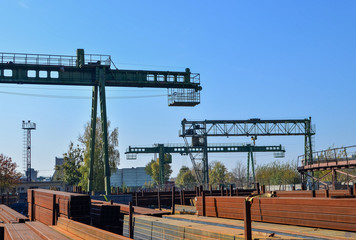 Warehouse of metal products, metal, on the background of a gantry crane on an industrial site