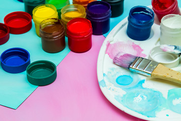 in jars of multi-colored paint for drawing