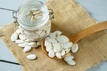 Pumpkin seeds in a glass jar, closeup
