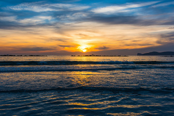 Small waves by the shore in Alghero at sunset