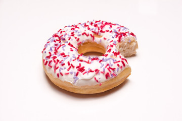 donut with a bite taken out on a white background