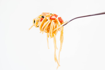 Spaghetti Carbonara with some parsley on a fork on a white background
