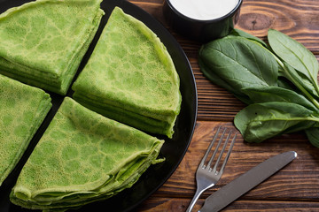 Homemade green pancakes with spinach . healthy crapes