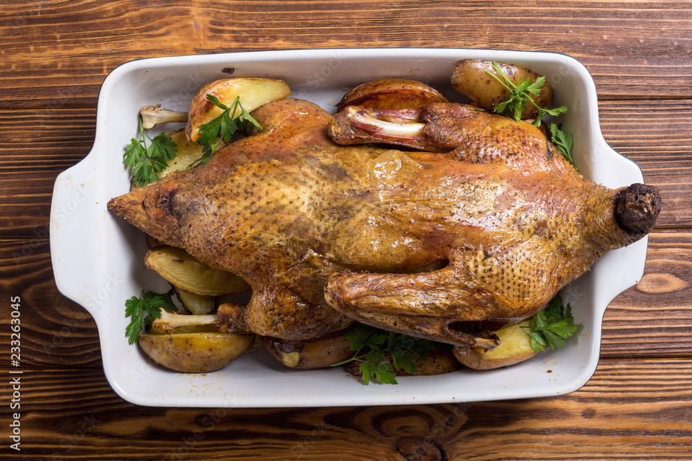 Wall mural homemade baked duck with potatoes and apple . christmas food