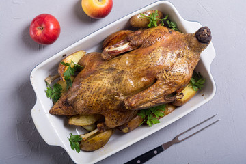 Homemade baked duck with potatoes and apple . Christmas food