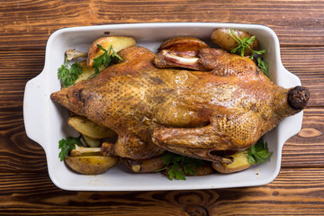Homemade baked duck with potatoes and apple . Christmas food