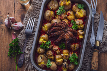 Octopus and potato in a baking tray close view