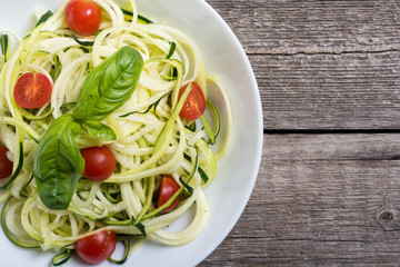 Zucchini pasta noodles with tomatoes . Healthy vegetarian food