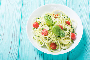 Zucchini pasta noodles with tomatoes . Healthy vegetarian food