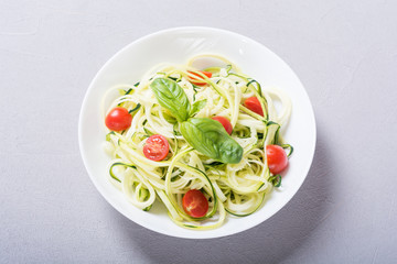 Zucchini pasta noodles with tomatoes . Healthy vegetarian food