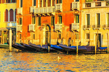 Fototapeta na wymiar Gondolas near a venetian palace in the Grand Canal