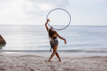 Girl at the beach with hula hoop