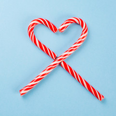 lollipops in the shape of a heart on blue background