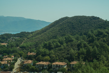 Fototapeta premium Mountain town panoramic view. city between the hills