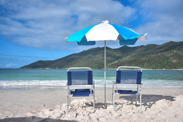 two chairs and umbrella on the beach