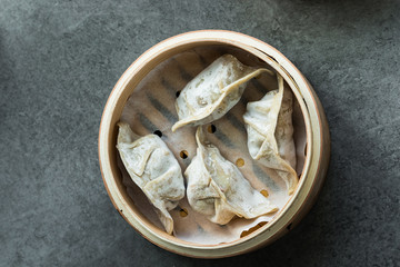 Bamboo steamer with wontons for cooking. flat lay.