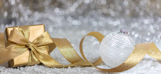 Fototapeta na wymiar Christmas balls and gift, abstract bokeh lights background
