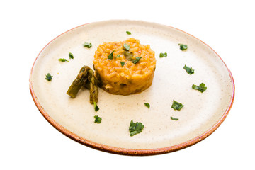 Risotto with cream of asparagus on a white background
