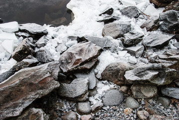 Ice and granite rocks on the beach