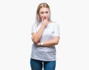 Fototapeta premium Young blonde woman over isolated background looking confident at the camera with smile with crossed arms and hand raised on chin. Thinking positive.